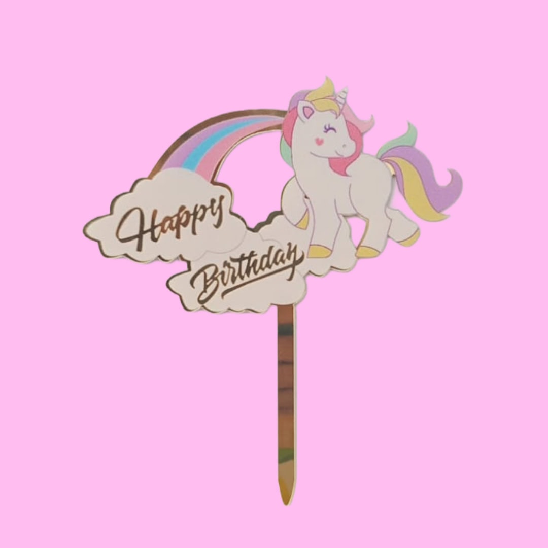 Unicorn Happy Birthday topper with a pastel mane and golden horn on a birthday cake.