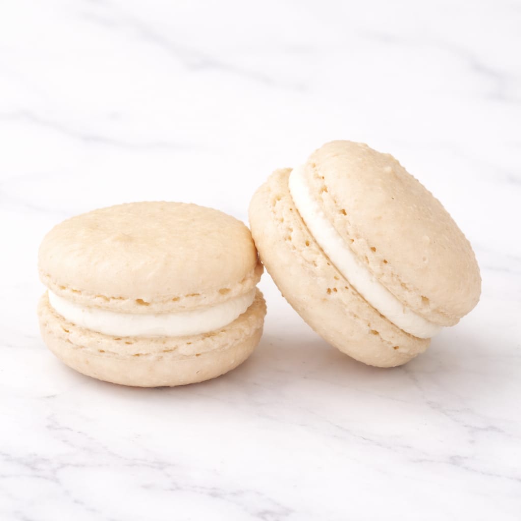 Elegant vanilla macaron with a creamy center.