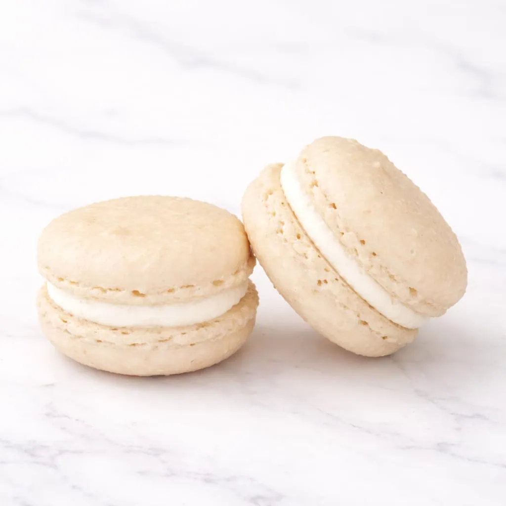 Elegant vanilla macaron with a creamy center.