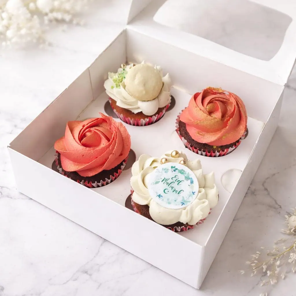 Box of 4 Suikerfeest cupcakes with red velvet and strawberry pistachio flavors