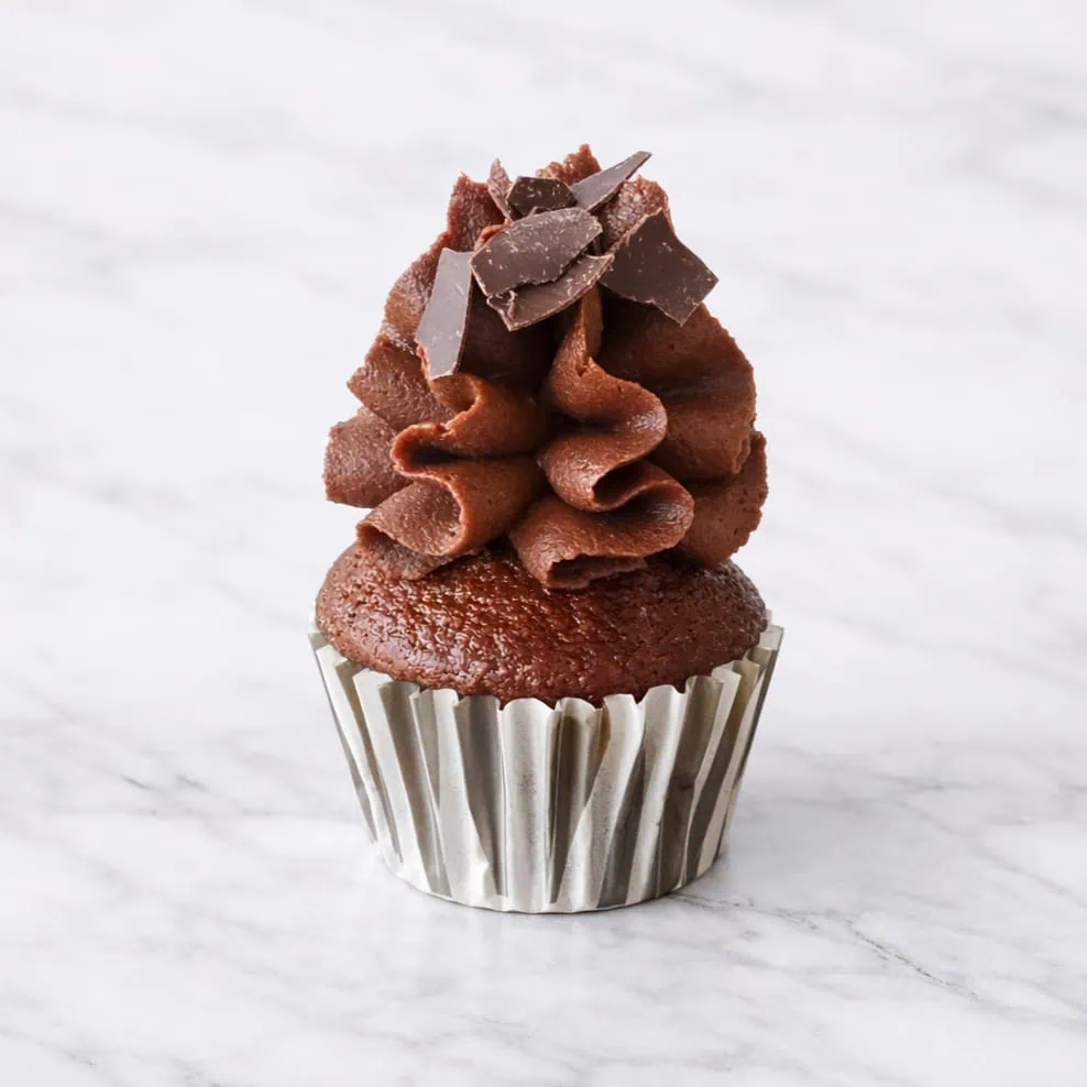 Mini chocolate cupcake with rich cocoa base and chocolate buttercream frosting.