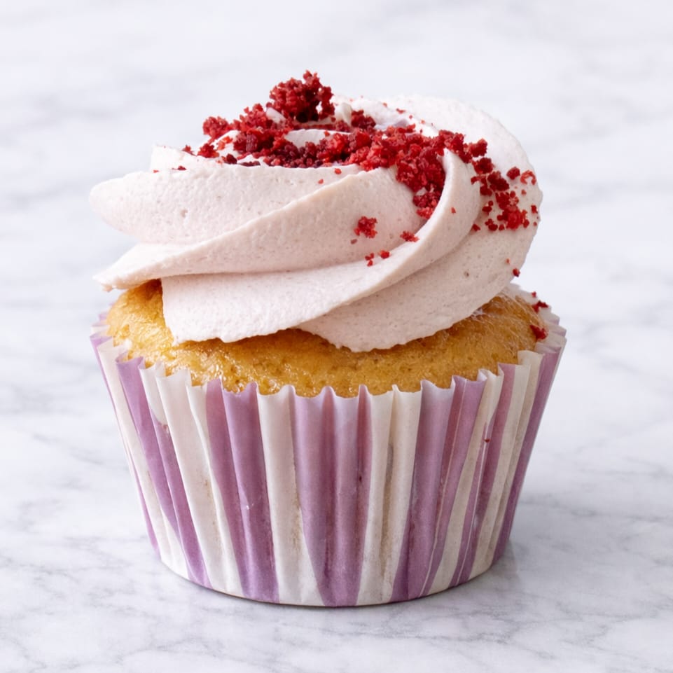 Vegan cherry cheesecake cupcake with creamy frosting.
