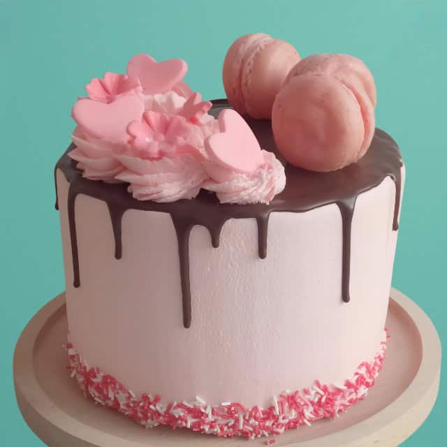 Macaron drip cake with pure chocolate drip and macaron toppings.