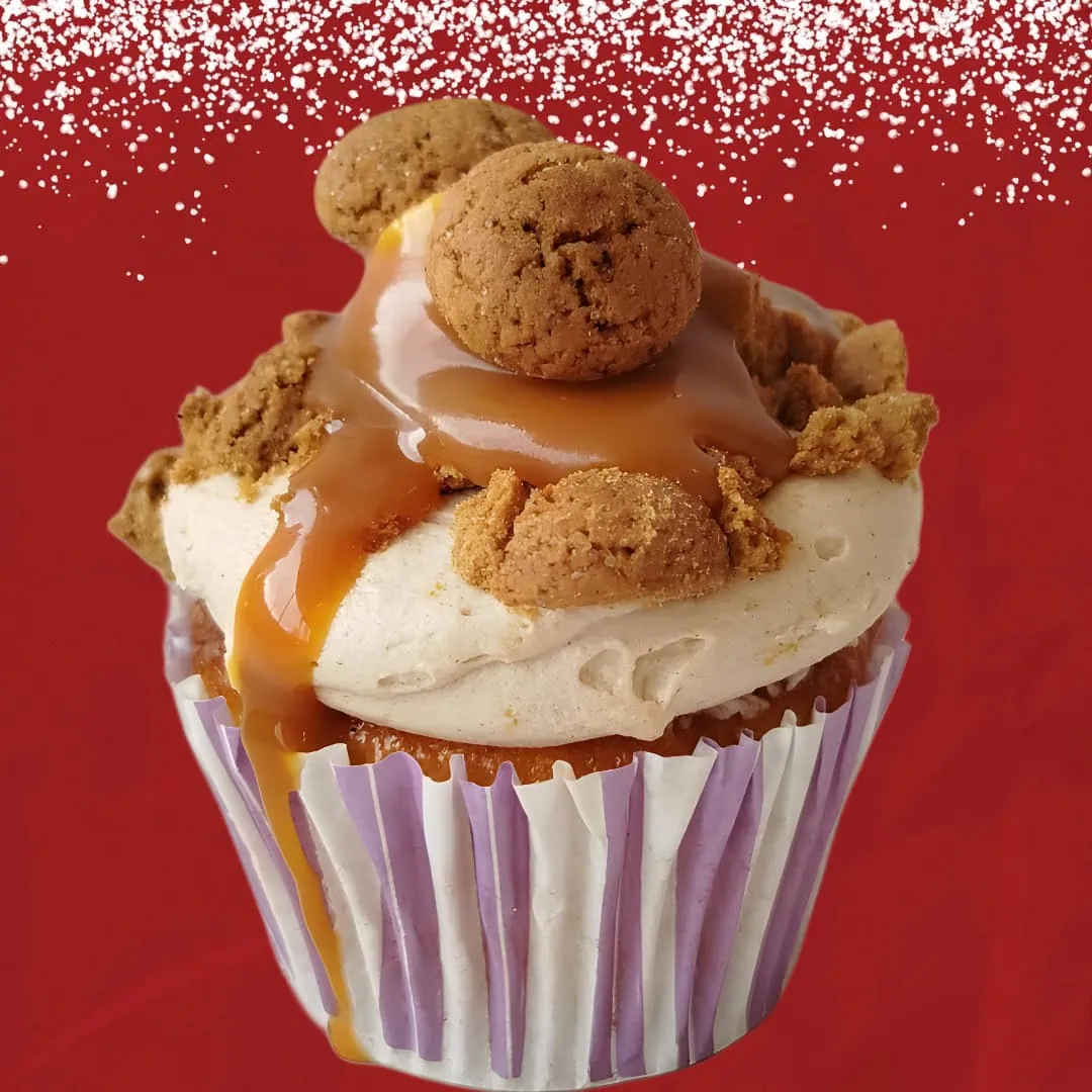 Sinterklaas gingerbread speculaas cupcake with spiced frosting, caramel drizzle, and kruidnootjes