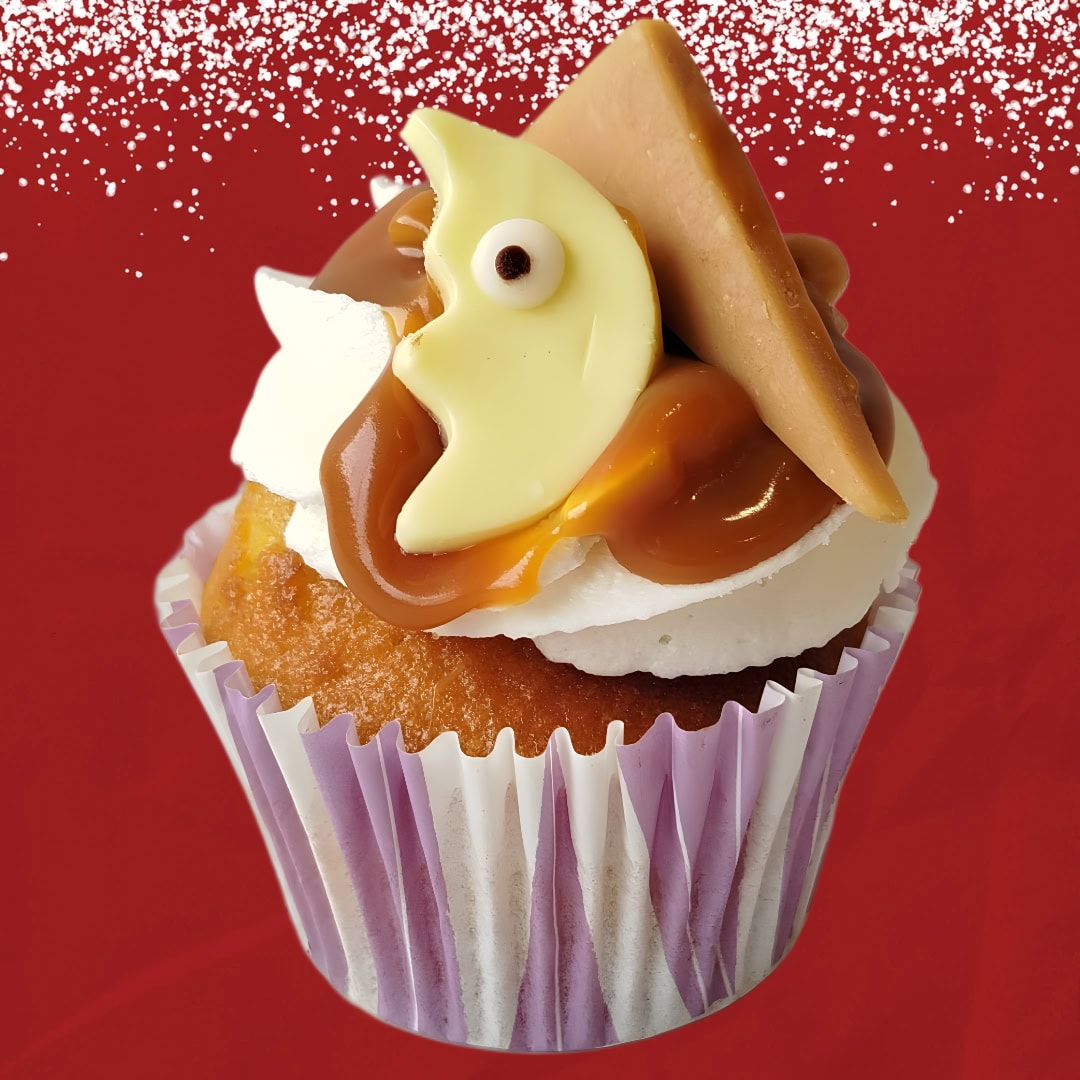 Sinterklaas salted caramel cupcake with vanilla frosting, caramel drizzle, and festive chocolate decorations