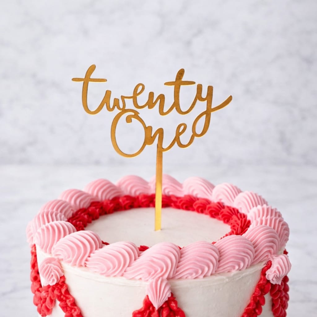 Gold "Twenty One" acrylic cake topper for a birthday cake.