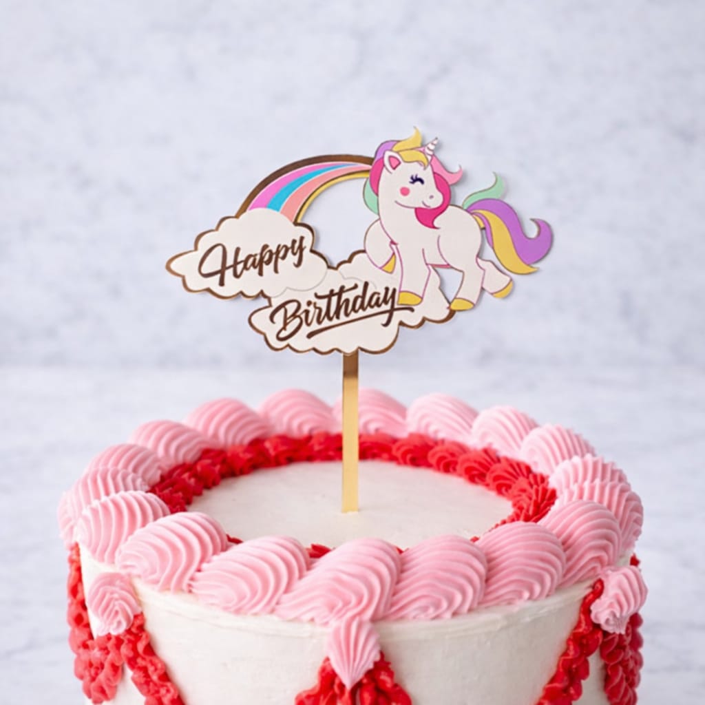 Unicorn Happy Birthday topper with a pastel mane and golden horn on a birthday cake.