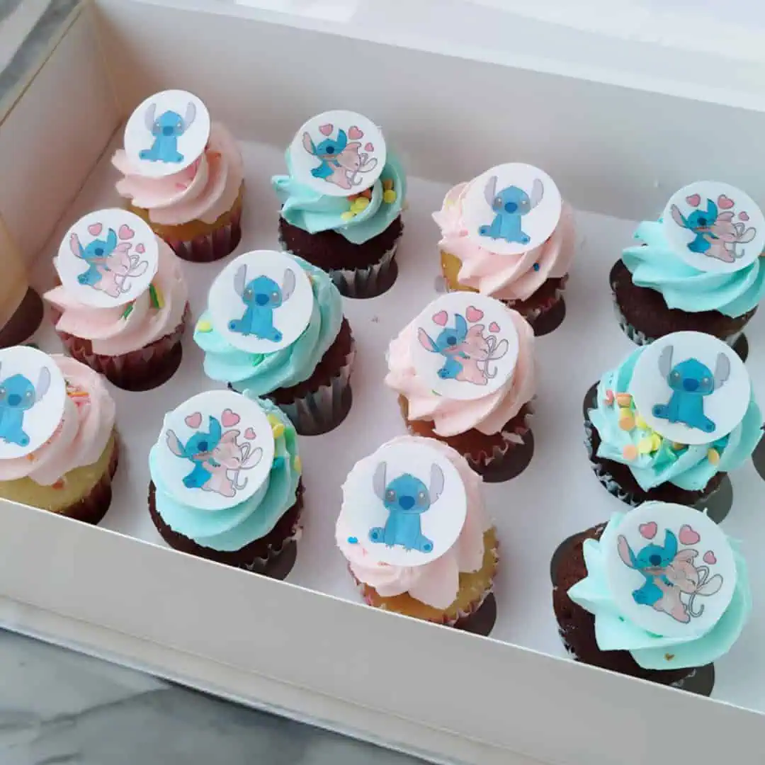 12 Stitch Cupcakes Box with colorful fondant images of Lilo and Stitch on vanilla and chocolate cupcakes, perfect for themed parties and kids’ birthdays.