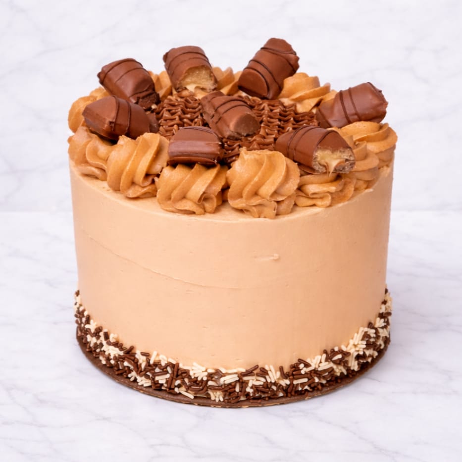 Bueno cake topped with hazelnut buttercream and Bueno pieces.