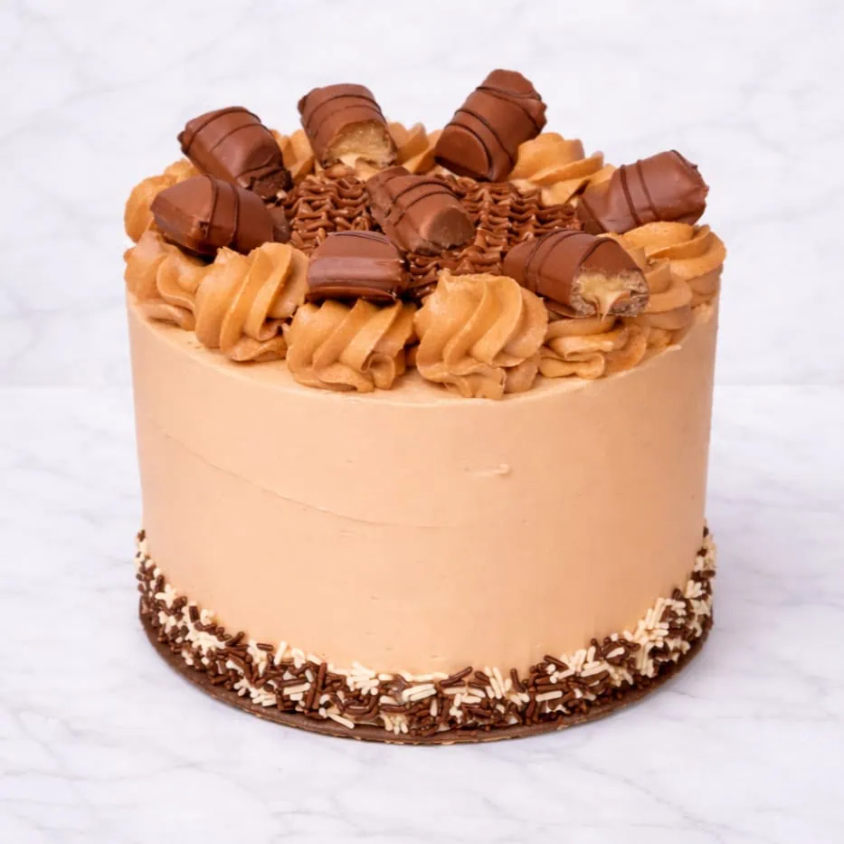 Bueno cake topped with hazelnut buttercream and Bueno pieces.