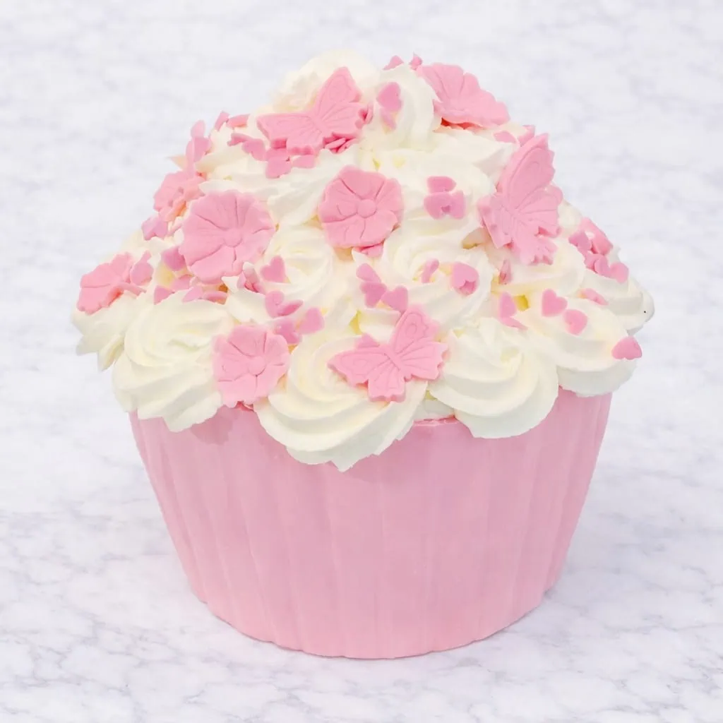 Customizable giant cupcake with options of Red Velvet or Vanilla and Strawberry flavors, decorated with choice of fondant color and sugar decorations like flowers and butterflies.
