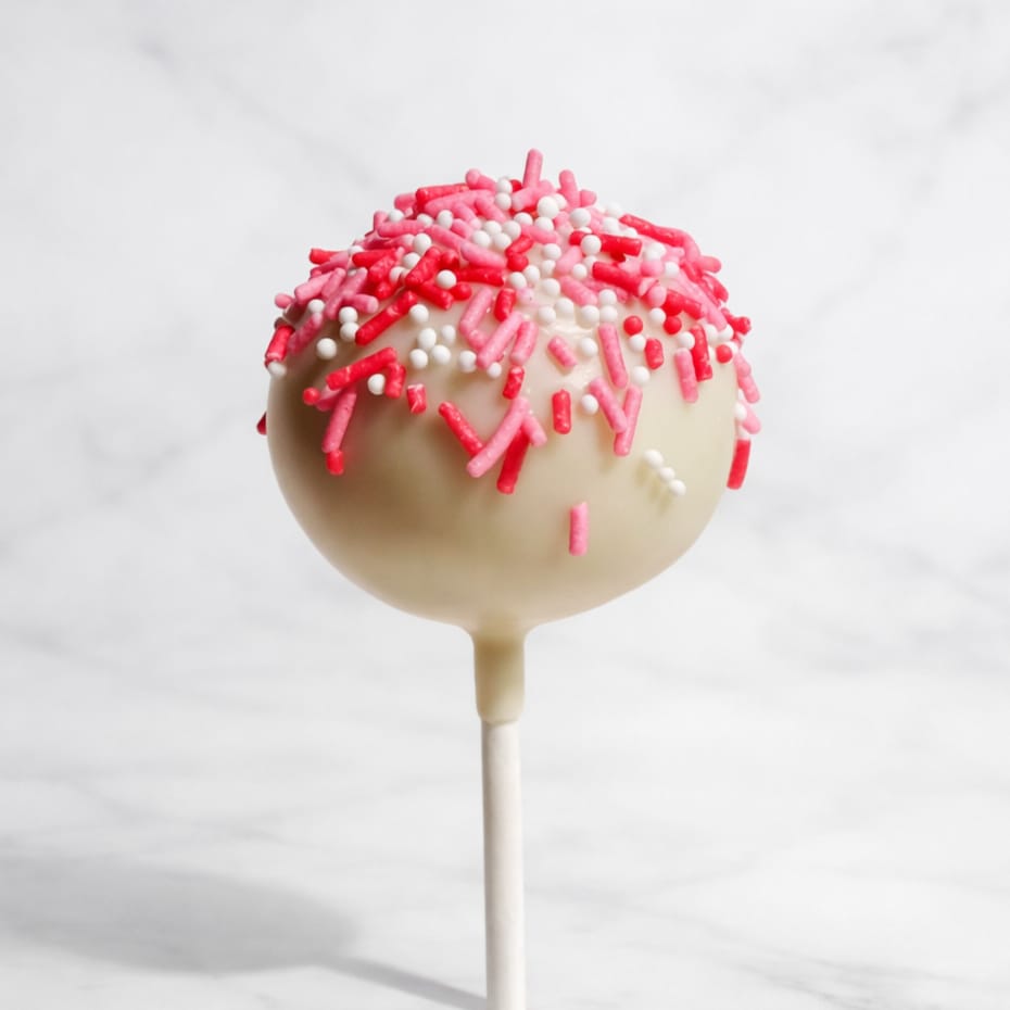 Red velvet cakepop dipped in white chocolate, decorated