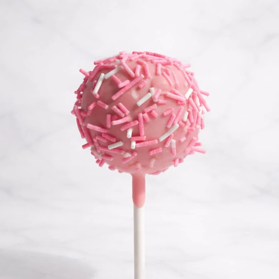Baby pink cakepop with vanilla cake and pink and white sprinkles.