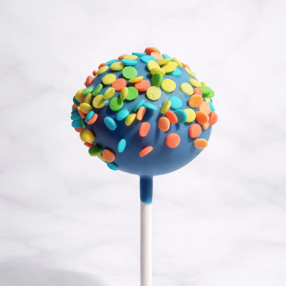 Blue cakepop dipped in blue chocolate and topped with multicolored confetti sprinkles.